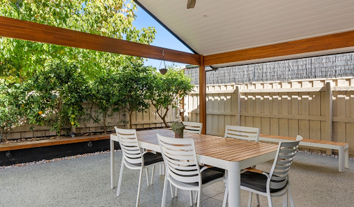 A table and chairs in a home extension.