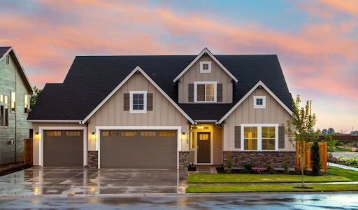 A house with a wet driveway and roads outside