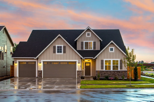 A house with a wet driveway and roads outside